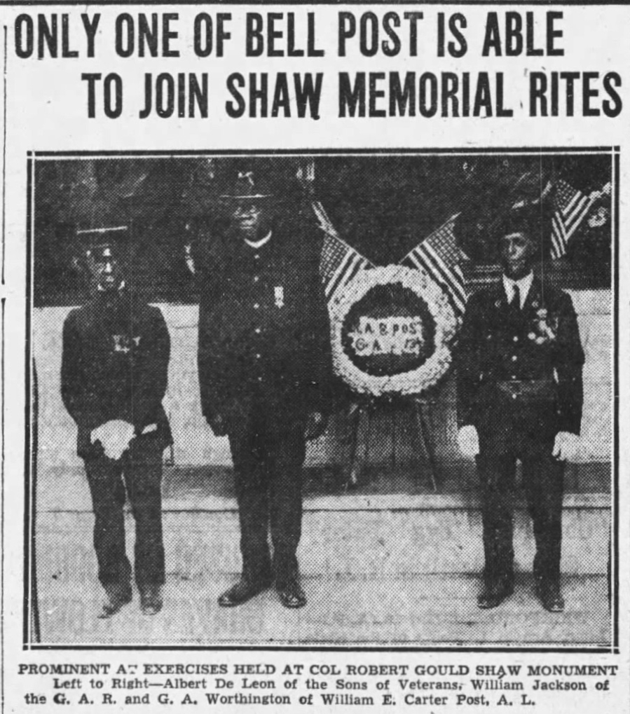 Photograph of three veterans in their uniforms standing in front of the Shaw Memorial.